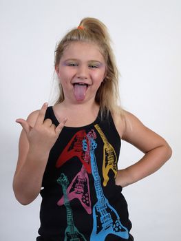 A young girl with a rock gesture