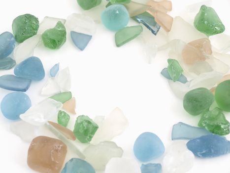 Colorful stones of glass in various blue tones isolated over a white background.