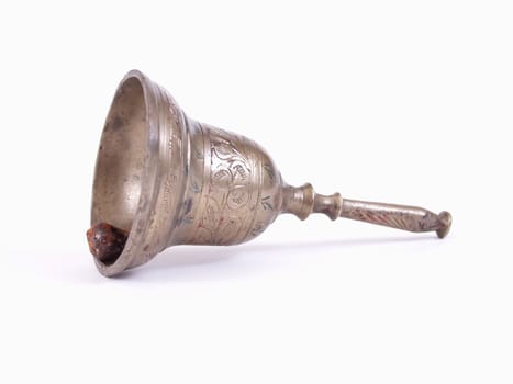An antique etched brass bell isolated over a solid white background.