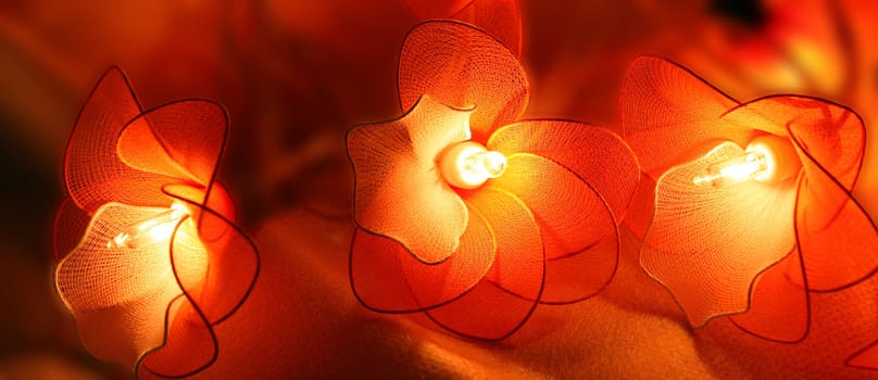 Decorative  flower-designed chinese  flashlights. Handmade, accomplished from  half-transparent fabric.  Softly  painted in orange and red. Making aura of well being and luck