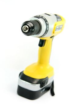 yellow rechargeable drill isolated on white background industrial tools