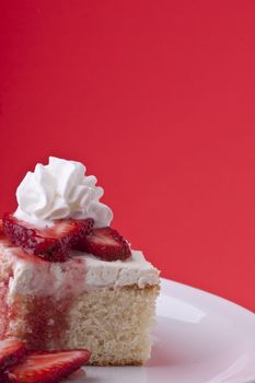strawberry shortcake on a red background sliced berries and whipped cream
