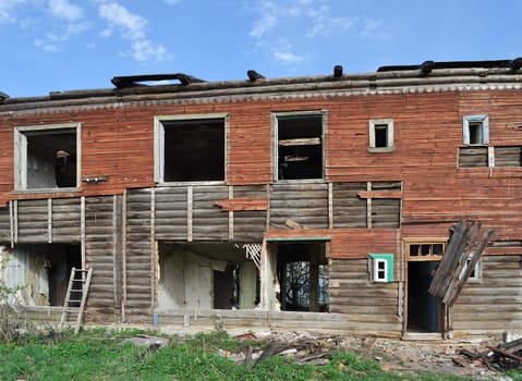 Facade of old abandoned destroyed wooden house