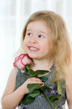 beautiful little girl with pink of rose