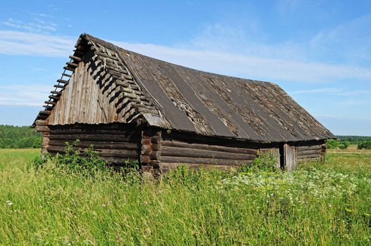 Old abandoned wooden barn at village outskirts