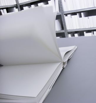 Open white Book with blank Pages in a white Library