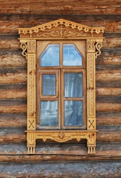 Carving decorated window in country wooden house, Russia