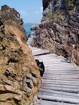 Seaside wood bridge between cliff in Ko Kham island, Sattahip, Chon Buri, Thailand