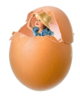 little girl in blue dress in broken egg shell closeup on white background