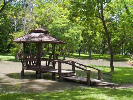 Wood pavilion on marsh in garden