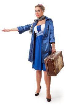 young woman dressed in retro style with an old suitcase