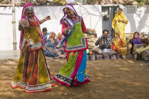 Beautiful tribal dancers in colorful costume performing in Jaipur, Rajasthan, India