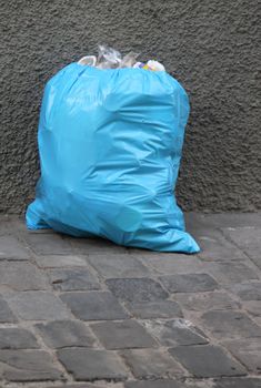 One blue garbage pack in the street