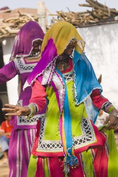 Veiled tribal dancers in colorful costume performing in Jaipur, Rajasthan, India