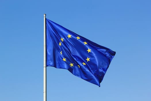 Blue flag of the european union with its yellow stars by beautiful weather