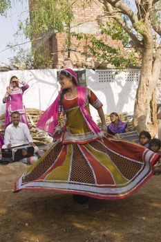 Beautiful tribal dancer in colorful costume performing in Jaipur, Rajasthan, India