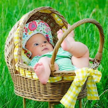 A beautiful little baby girl in the grass