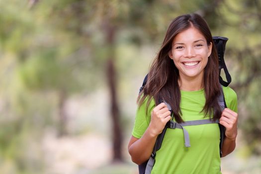 Woman hiking portrait with copy space. Fresh and healthy looking female model during hike outdoors in forest. Beautiful mixed race Caucasian / Chinese Asian young woman. Image from volcano Teide, Tenerife, Canary Islands, Spain.