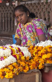 Woman selling flowers near a Hindu temple in Jaipur, Rajasthan, India