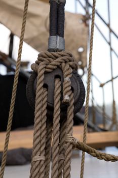 Old wooden block with rope. 