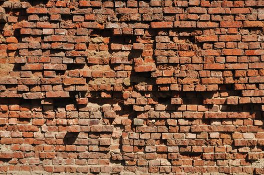 Fragment of old destroyed brick wall background
