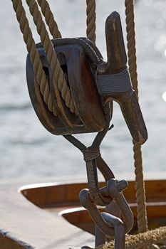 Old wooden block with rope. 