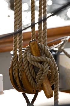 Old wooden block with rope. 