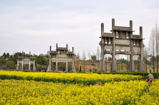 Landmark of Chinese ancient Memorial Archway in the blooming rapeseed fields