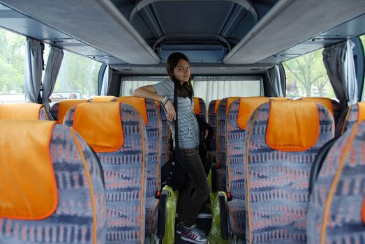 smiling teenage standing girl in touristic bus