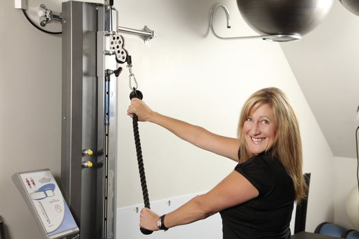 Woman exercising on a machine