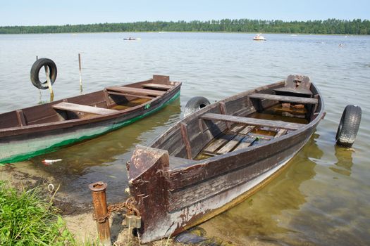 wooden boat over the riverside of lake