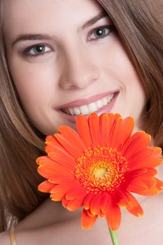 Beautiful smiling woman holding flower