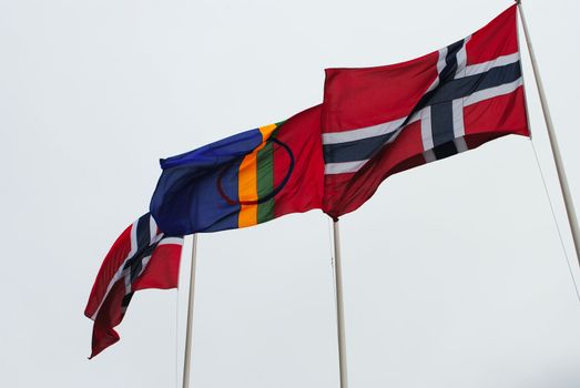 Flying norwegian and sami flags during norwegian national day celebration 17th of may.