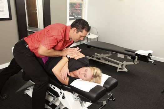 Chiropractor adjusting a female patient