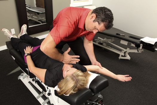 Chiropractor adjusting a female patient