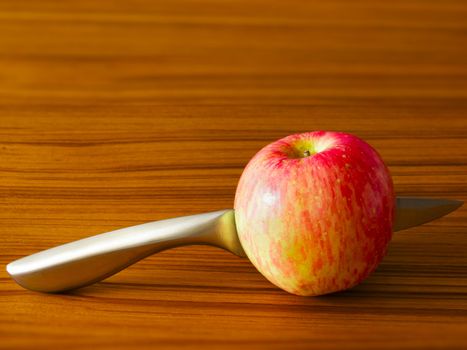 close up of red apple with knife