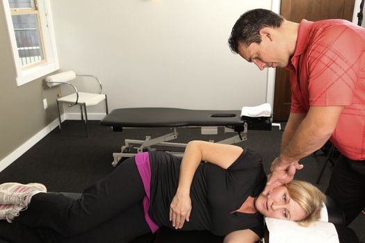 Chiropractor adjusting a female patient