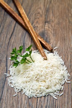 uncooked rice grains in wood bowl 