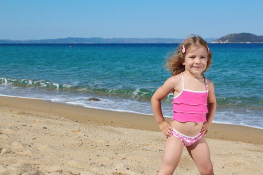 beauty little girl posing on the beach