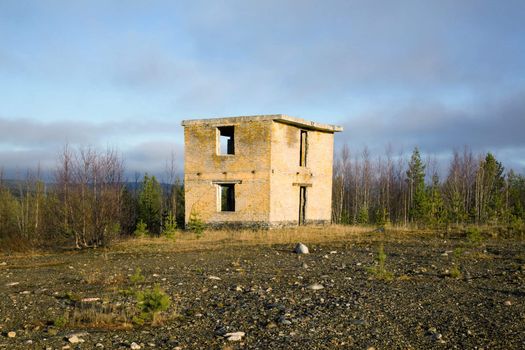 Abandoned building military ground control point range against the background of an autumn forest