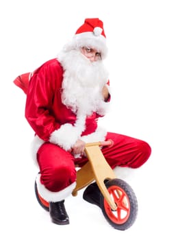 Photo of happy Santa Claus on bike with red sack. Isolated over white background