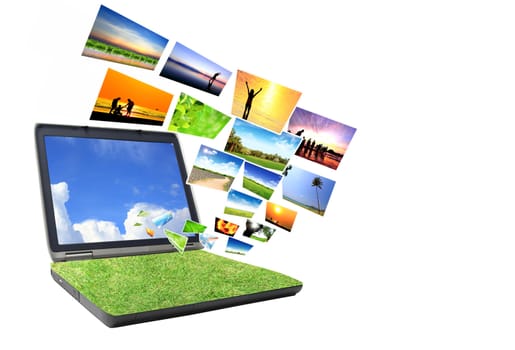 Multimedia concept with modern laptop on green field