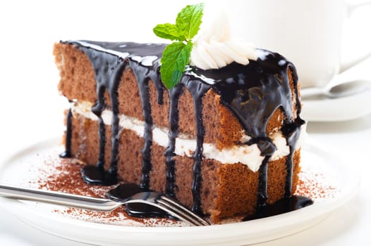 A piece of chocolate cake with vanilla cream