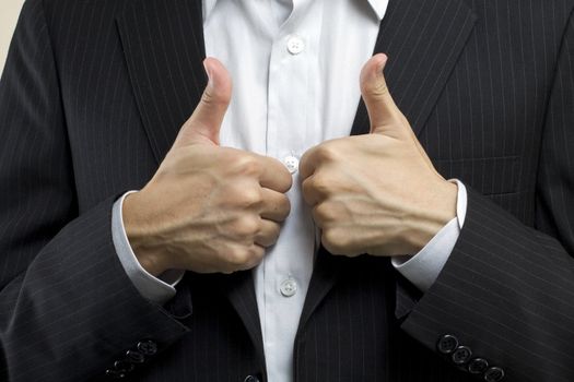 Business man with thumbs up, means successful deal.