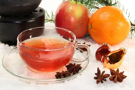 a cup of winter tea with fruit and spices