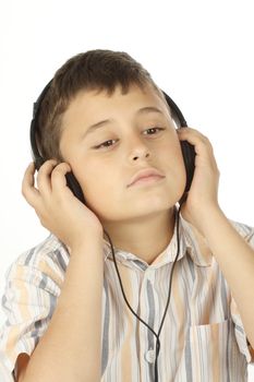 Boy with headphones listening to music over white