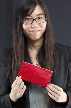Chinese business woman holding a Chinese red packet and wishing you happy Chinese New Year
