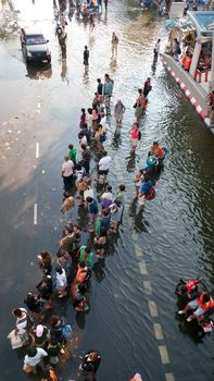 BANGKOK, THAILAND - NOVEMBER 6: Bus passengers waiting for transportation into a flooded area during the worst flooding in decades in Bangkok, Thailand on November 6, 2011.
