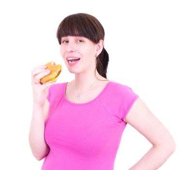 The young woman eats a hamburger