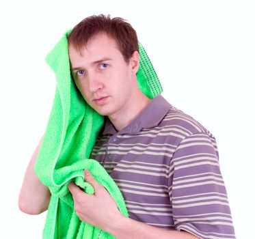 The young man wipes a head a terry towel